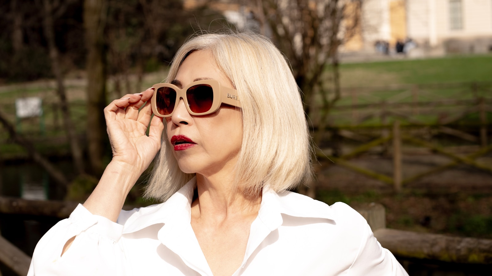 A woman in a white shirt and sunglasses
